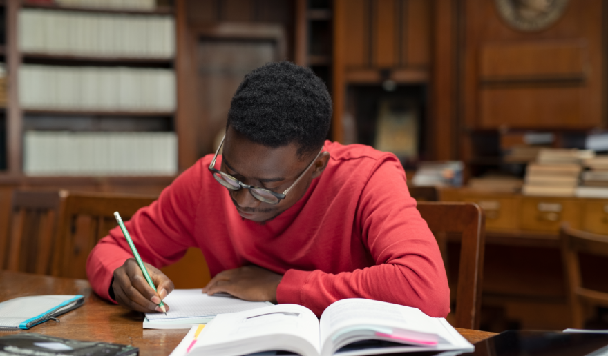 High school student studies in library