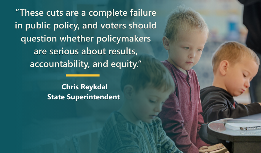 Children looking down at a desk at school