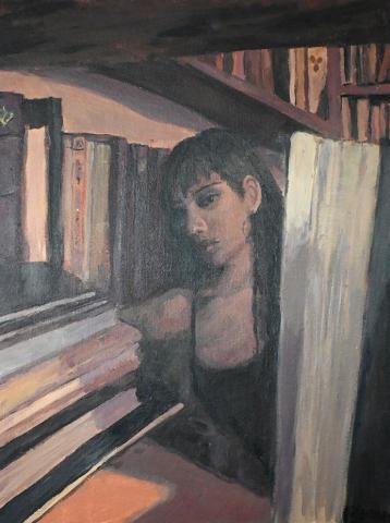  a person in what appears to be a library or study room. The person's face is partially obscured by a large book in the foreground