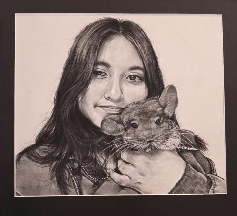 "Me and Mochi" is a charcoal self-portrait of me and my chinchilla. I was inspired to do it by my love of animals. I focused on realistic texture, contrast, and shading to make it lifelike and show our special bond.