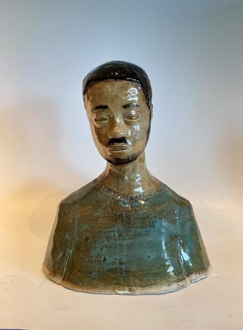 I used a copper green and a meadow green for the body or shirt that he's wearing. Although his hair is a different story containing a mix of matt and shiny glaze to capture the uniqueness of his hair. For the rest of "Him" I wanted it to look more like a statue so I limited the layers on the shirt and the body I used a flat brown to look erroded and old. Like he's been staring off into the distance for a long time.