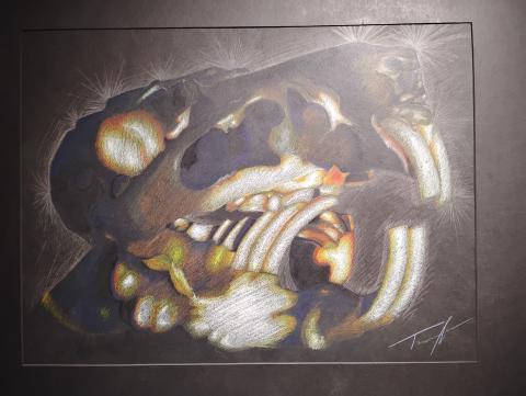 This piece is drawn on a black 24 by 18 inches of paper. On the paper is a guinea pig skull, that is a sort of block shape to it, broken by the jaw bone in the back and the buck teeth in the front. The eye socket, bottom center of the jaw, and most of the teeth, are colored mostly with white and have a fade from yellow to orange around it. Everything else mostly shaded in purples and blues, with the nostril socket having minimal yellow and orange.