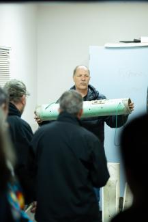 A man talking to a group of people.