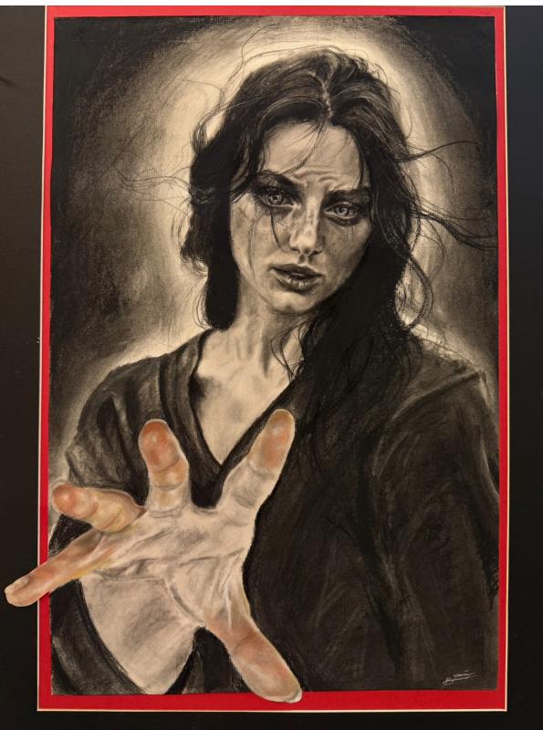 A portrait of a woman with intense eyes and disheveled hair, reaching forward with an outstretched hand that breaks through the red-bordered frame.