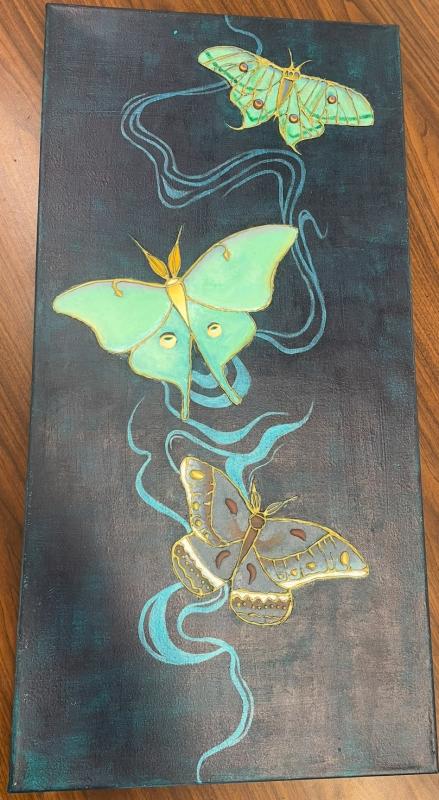 The artwork features three butterflies with intricate designs in shades of green and yellow.