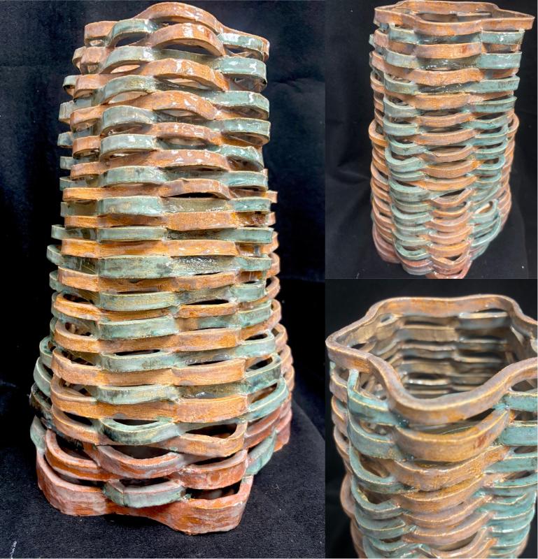 A ceramic vase with a unique, wavy, and layered design. The vase features alternating bands of earthy brown and turquoise colors