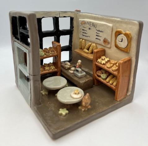 A 3D ceramic creation of a bakery with a realistic display of its interior