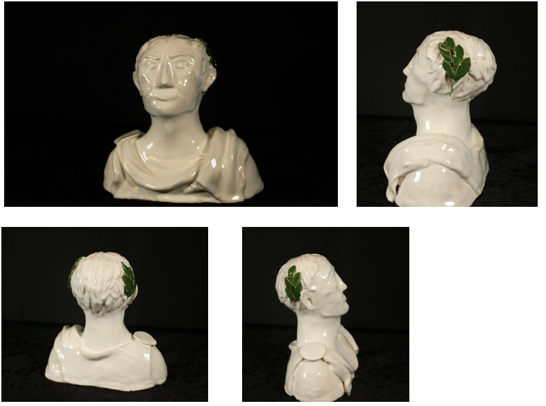 A ceramic representation of Julius Caesar using classic all white with a green leaf adorned on his head.