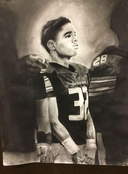 A charcoal drawing of a young football player looking hopefully toward his future