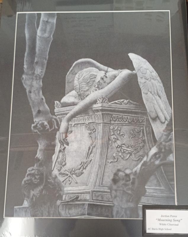 A grave with a gothic architectural theme. An angel draped over grave in a resting position. Arms covered in cracks. Eerie atmosphere. Contrast form the black base and white charcoal.