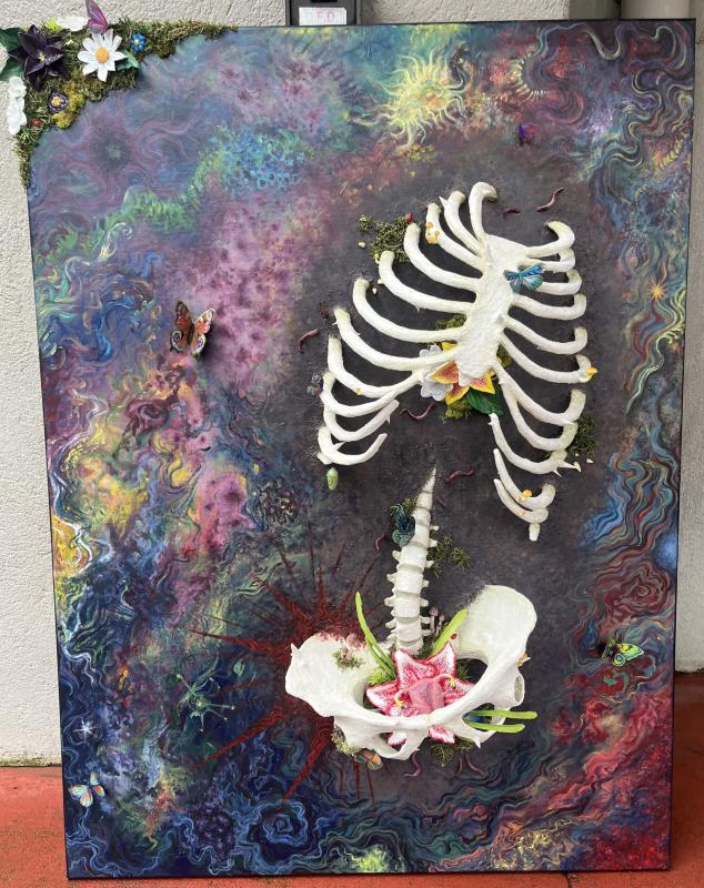 A human skeleton decomposing and bringing forth plant life. 3x4ft, 3D mixed media.