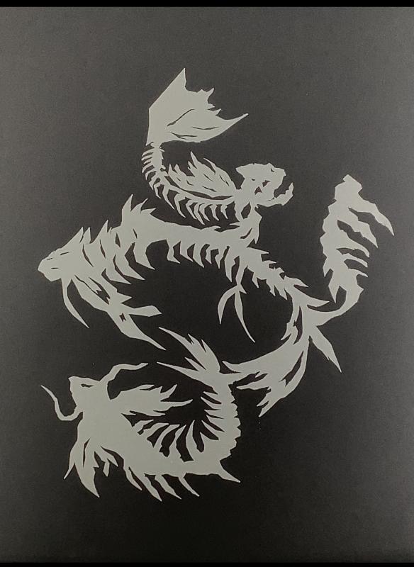 The image is compiled of white cut out in the style of a German Schereschnitte on the black background made of paper