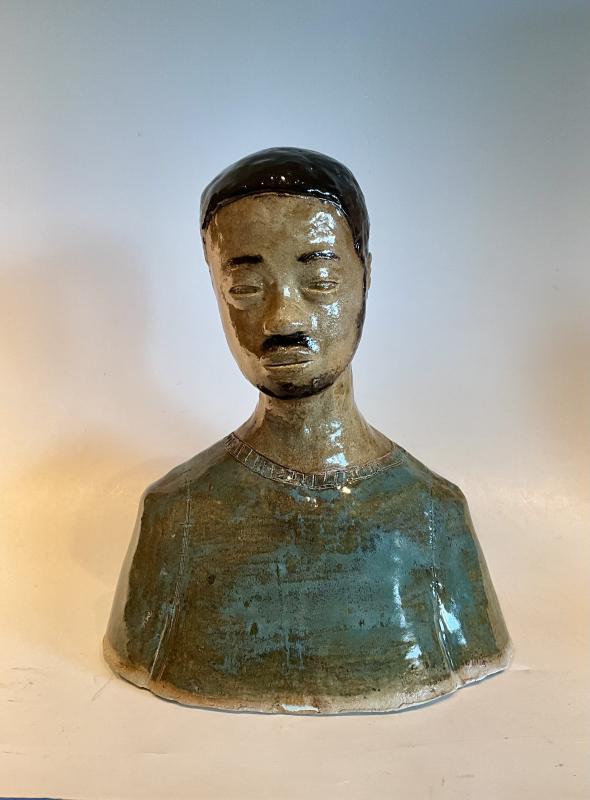 I used a copper green and a meadow green for the body or shirt that he's wearing. Although his hair is a different story containing a mix of matt and shiny glaze to capture the uniqueness of his hair. For the rest of "Him" I wanted it to look more like a statue so I limited the layers on the shirt and the body I used a flat brown to look erroded and old. Like he's been staring off into the distance for a long time.