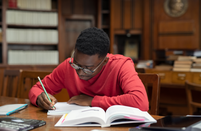 High school student studies in library