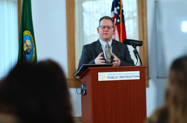 Superintendent Reykdal behind a podium