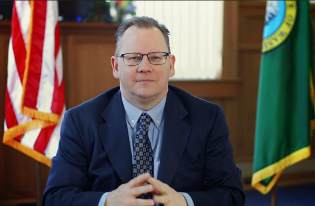 The superintendent sitting at a desk.