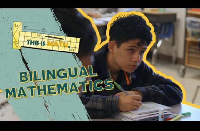 Student looking toward the board in a classroom, writing notes